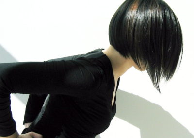 lady with short shiny black hair wearing a black shirt